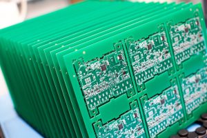 A stack of Printed Circuit Boards, which form the backbone of nearly every electronic device today, from smartphones and medical devices to industrial machinery and automotive systems.