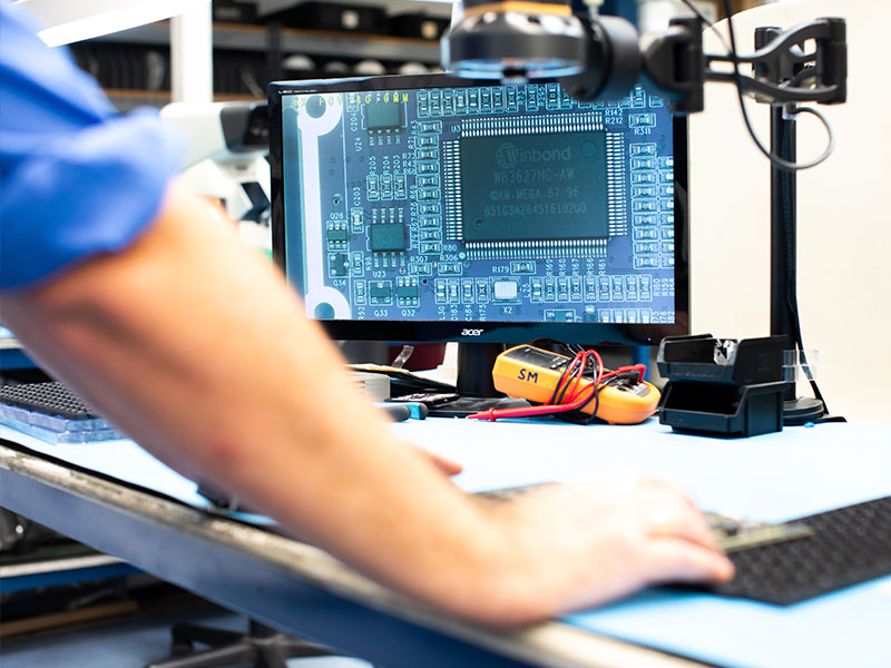 A member of the MPE Electronics team assesses a PCB assembly design.